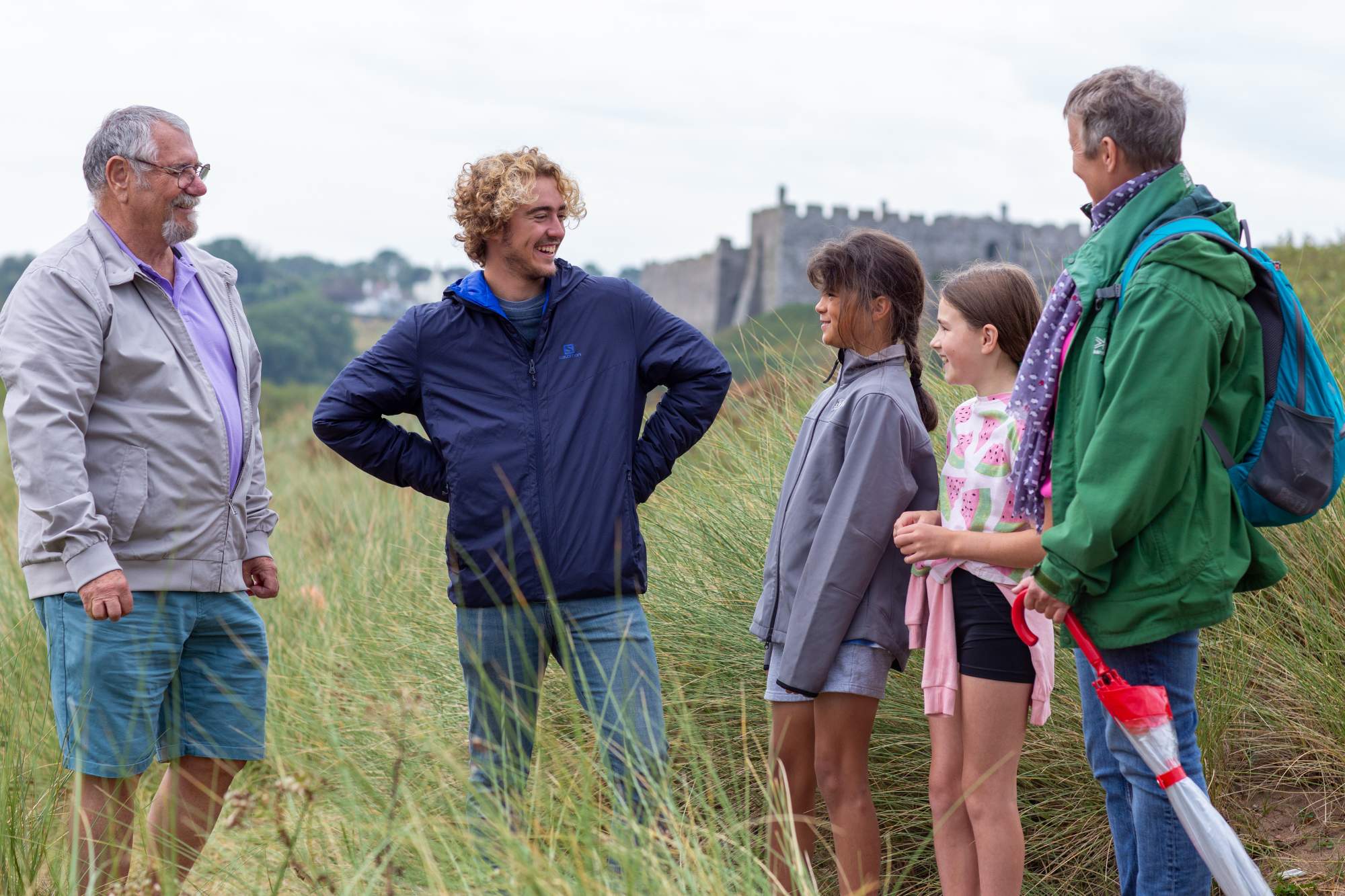 A family standing together in front of a castle
